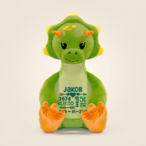 Grønn dinosaurus bamse med navn og dato brodert på magen.